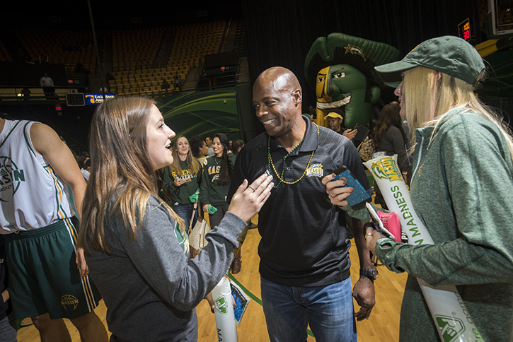 Darrel Green interacts with students on the floor of EagleBank Arena