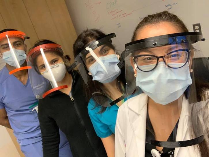 Medical professionals taking a selfie wearing their PPE from the Mason students.