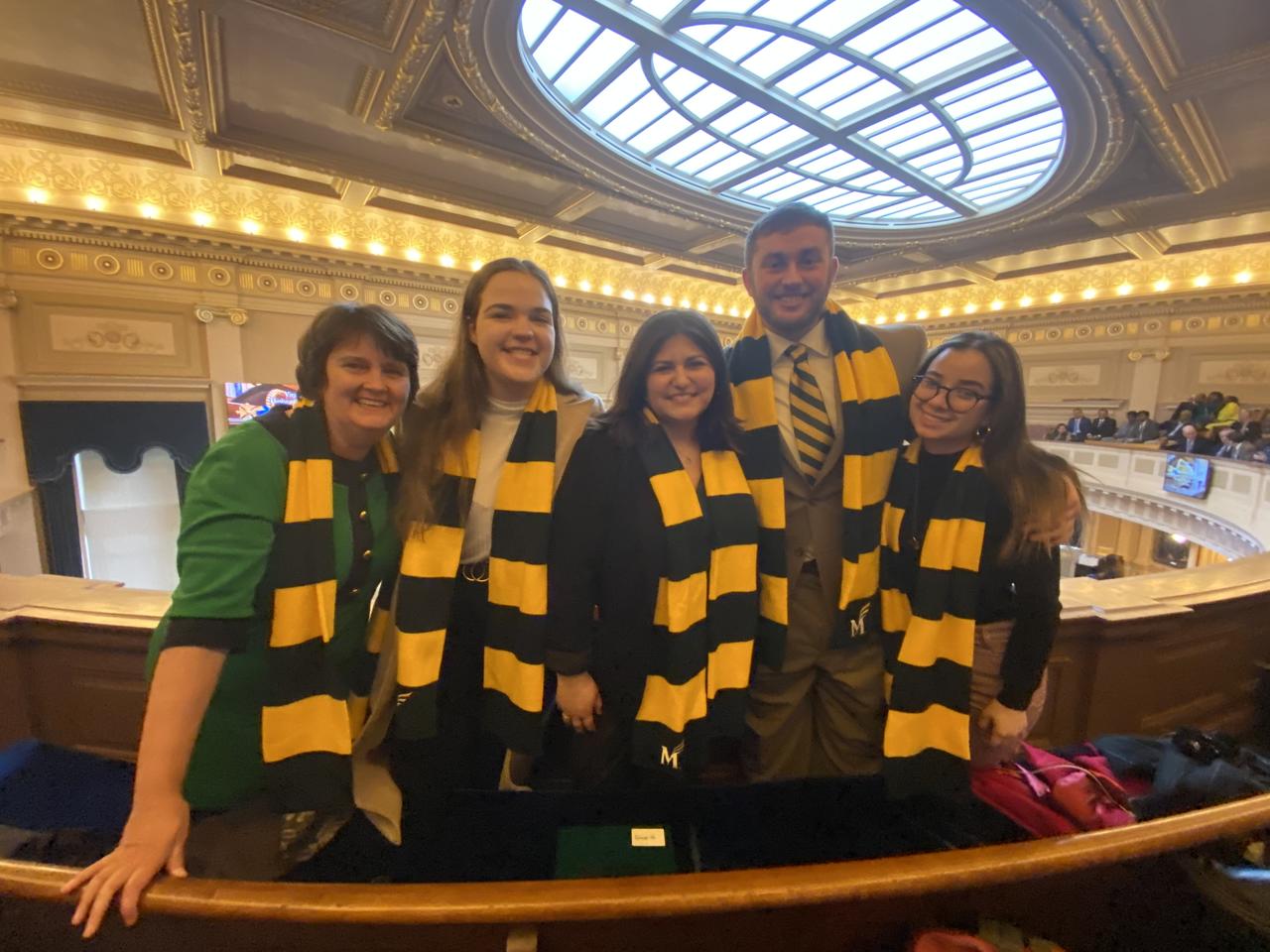 Then interim Mason President Anne Holton poses with students at Mason Lobbies at the Virginia State Capitol in February 2020. Mason senior Cassidy Whitehurst is second from right.