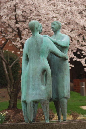 Bronze statue of three people embracing "Communitas" on the campus of George Mason University, Fairfax, VA USA