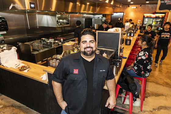Victor Albisu stands in front of the counter of his restaurant Taco Bamba