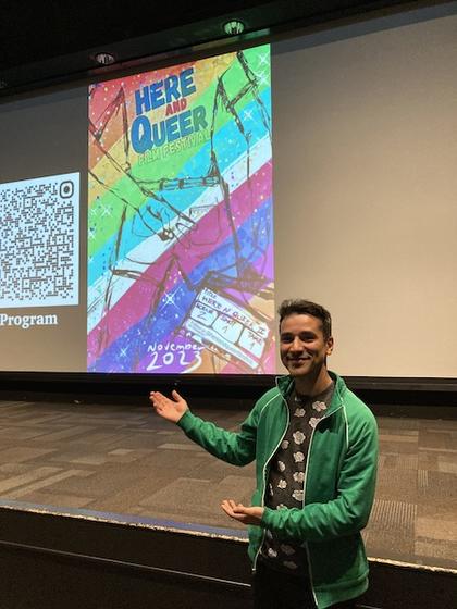 Roberto Ferreira de Araujo posing with the 'Here and Queer Festival' poster during on screening day. Photo provided.