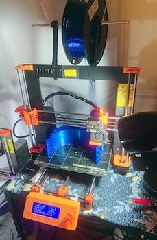 A 3-D printer printing a face shield.