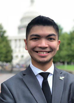 Headshot of Joseph Fernando standing in front of the U.S. Capitol.