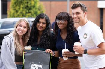 Students smile together at a Spring into Well-Being event